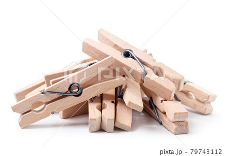 A pile of wooden clothespins on a white background. Isolated 79743112