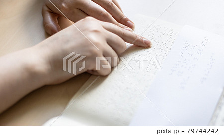 reading book and note with braille text 79744242