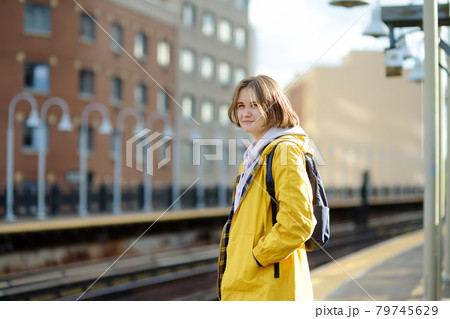 Beautiful young woman is waiting for a train on a platform in the New York subway. Transport of NYC, USA. Beautiful young woman is waiting for a train on a platform in the New York subway. Transport of NYC, USA. 79745629