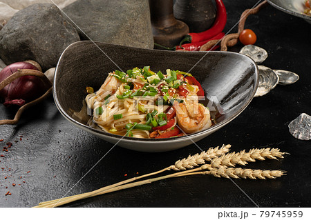 Udon noodles with shrimp and green onions 79745959