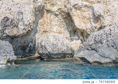 Small backwater surrounded by a stone cliff with azure water in Cyprus Small backwater surrounded by a stone cliff with azure water in Cyprus 79748069