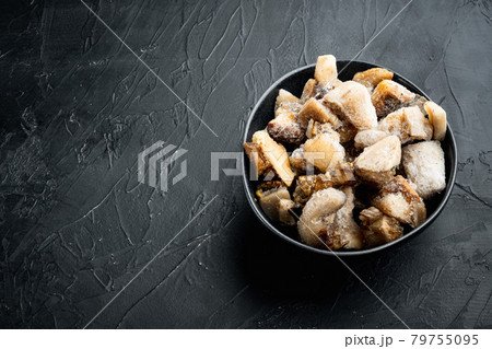 Frozen wild mushrooms, in bowl, on black stone background, with copy space for text Frozen wild mushrooms, in bowl, on black stone background, with copy space for text 79755095