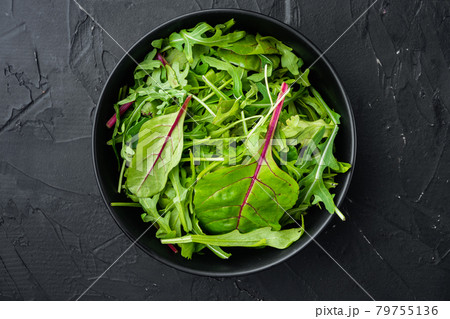 Mix Salad leafs, Swiss chard and Arugula, on black stone background, top view flat lay, with copy space for text 79755136
