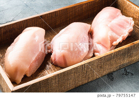 Raw chicken meat fillet, in wooden box, on gray stone background 79755147