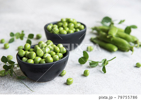 Fresh green peas pods and green peas with sprouts on concrete background. 79755786