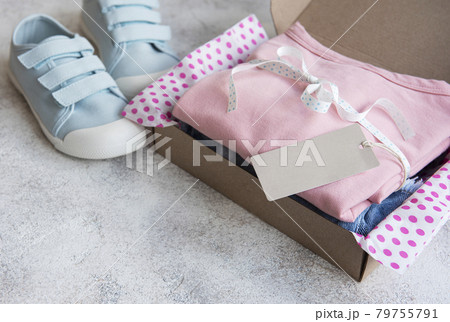 Clothes fir kids in an open cardboard box 79755791