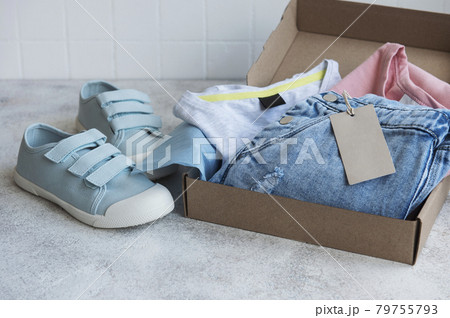 Clothes fir kids in an open cardboard box 79755793