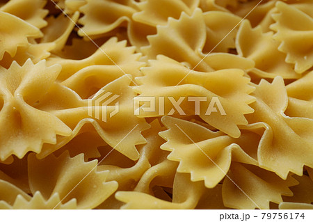 Uncooked pasta on whole background, close up Uncooked pasta on whole background, close up 79756174