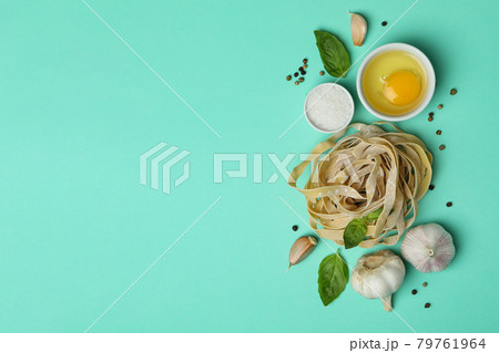 Concept of cooking tasty pasta on mint background Concept of cooking tasty pasta on mint background 79761964