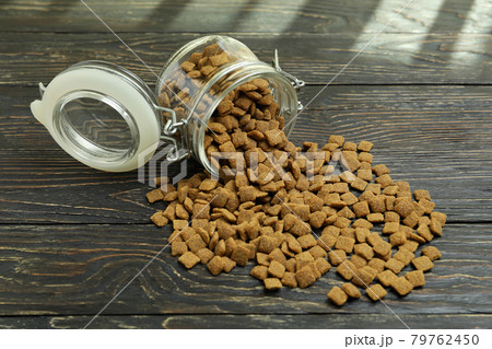 Glass jar with pet feed on wooden background 79762450