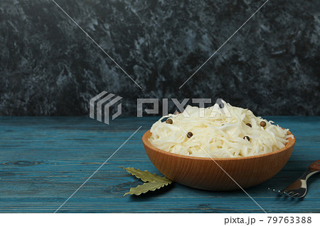 Wooden bowl with sauerkraut and fork on wooden table Wooden bowl with sauerkraut and fork on wooden table 79763388
