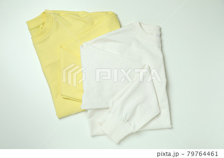 White and yellow sweatshirts on white background 79764461