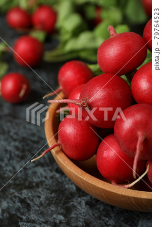 Bowl with fresh radish on black smokey table 79764523