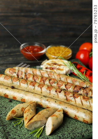 Concept of tasty food with grilled sausage on wooden table 79765253