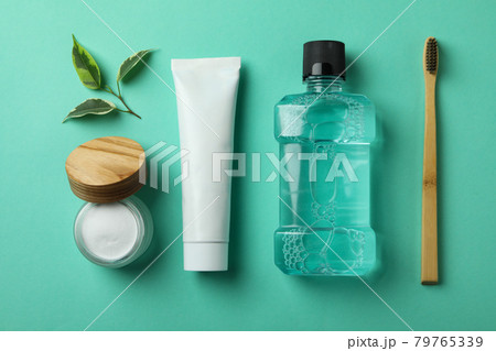 Oral care accessories on mint background, top view 79765339