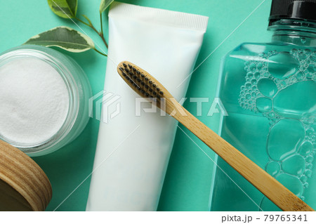 Oral care accessories on mint background, close up 79765341