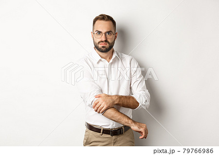 Angry man roll up sleeves and looking offended, getting ready to fight, standing over white background Angry man roll up sleeves and looking offended, getting ready to fight, standing over white background 79766986