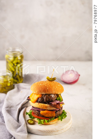Home made burgers with two cutlets and onion on a concrete gray background Home made burgers with two cutlets and onion on a concrete gray background 79768977