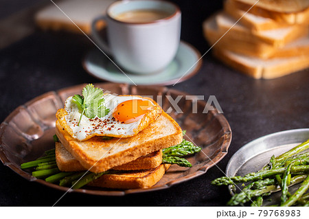 Fresh sandwiches with fried egg served on a vintage metallic plate, horizontal Fresh sandwiches with fried egg served on a vintage metallic plate, horizontal 79768983