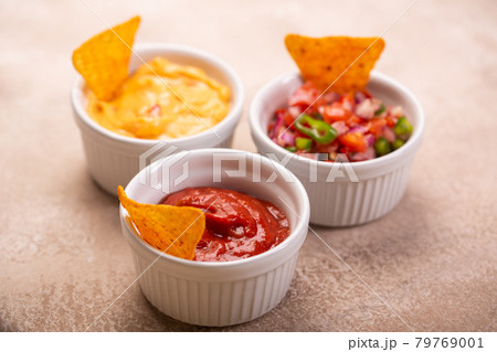 Three mexican salsa, pico de gallo, cheese and spicy tomato sauces Three mexican salsa, pico de gallo, cheese and spicy tomato sauces 79769001