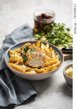 Pasta penne with cajun sauce and fried chicken 79769017