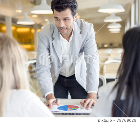 Cropped shot of businesspeople using graph chart and computer laptop, tablet discussing about business plan together in modern office. 79769029