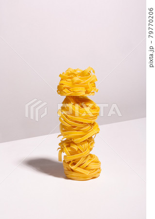 Laid out on top of each other spaghetti nests with a shadow Laid out on top of each other spaghetti nests with a shadow 79770206