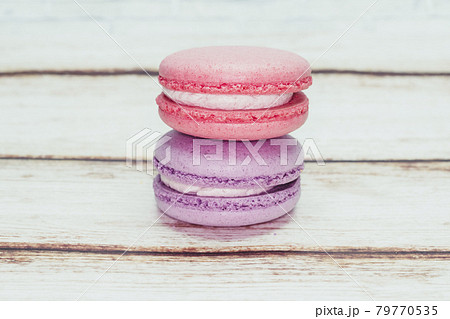 Multicolored macarons on a table and white wall background Multicolored macarons on a table and white wall background 79770535
