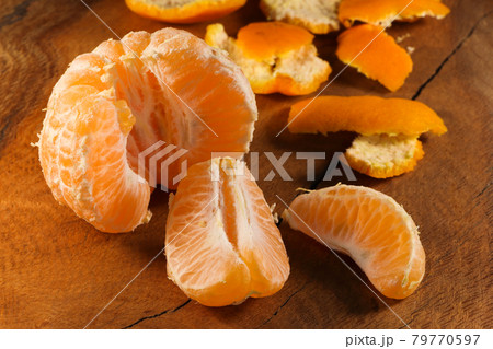 Peeled Satsuma Mandarin Tangerine Segmented Fresh Fruit (Citrus unshiu) Peeled Satsuma Mandarin Tangerine Segmented Fresh Fruit (Citrus unshiu) 79770597