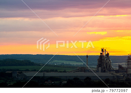 Yellow sunset over industrial landscape with factory chimneys and pipes with smoke polluting the atmosphere. Yellow sunset over industrial landscape with factory chimneys and pipes with smoke polluting the atmosphere. 79772097