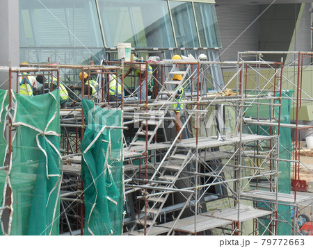 PUTRAJAYA, MALAYSIA -JANUARY 15, 2017: Construction workers wearing safety harness and adequate safety gear while working at high level at the construction site in Seremban, Malaysia. 79772663