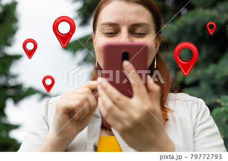 Traveler hands use map on mobile phone app to search for route location of place with gps on street when travel in city 79772793