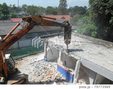 JOHOR, MALAYSIA -JUNE 26, 2016: Concrete hacking machine used to crush waste concrete to small pieces at the construction site in Malaysia. JOHOR, MALAYSIA -JUNE 26, 2016: Concrete hacking machine used to crush waste concrete to small pieces at the construction site in Malaysia. 79773989