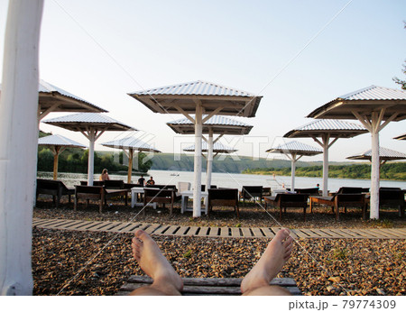 Relax on the beach. The guy is resting on the beach.  79774309