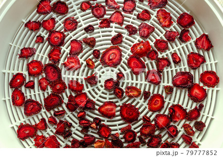 Sliced Strawberry Cooking Homemade Strawberry Chips in Vegetable Dryer. 79777852
