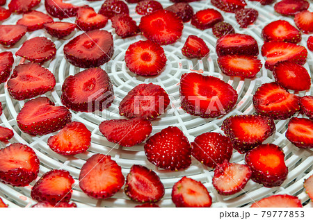 Sliced Strawberry Cooking Homemade Strawberry Chips in Vegetable Dryer. 79777853