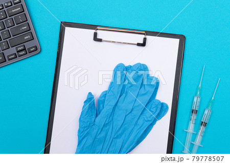 Vaccination or Revaccination Concept - Two Medical Syringe on Blue Table Vaccination or Revaccination Concept - Two Medical Syringe on Blue Table 79778507