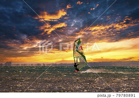 【夕日に向かって走るウィンドサーフィン 空合成】 【夕日に向かって走るウィンドサーフィン 空合成】 79780891