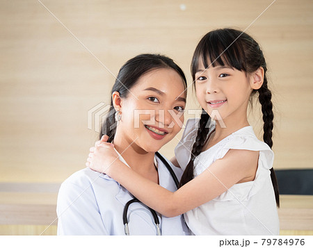 Portrait of a female doctor and a young female patient smiling brightly before being admitted to the hospital. 79784976
