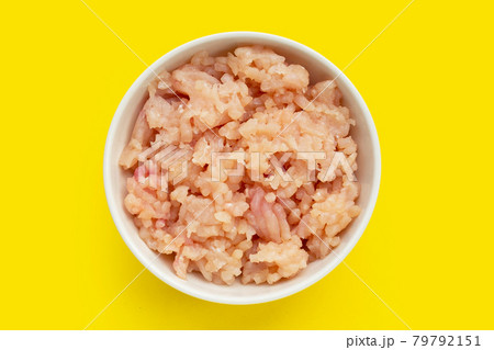 Minced meat of chicken fillet in white bowl on yellow background. Minced meat of chicken fillet in white bowl on yellow background. 79792151
