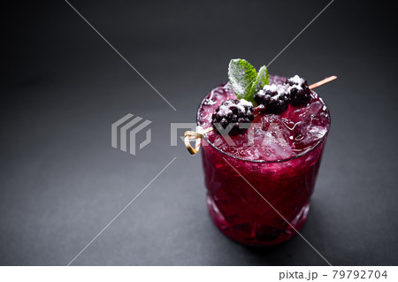 closeup of alcohol blueberry special cocktail with blackberry in wineglass 79792704