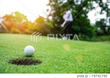 Close up golf ball on green grass field 79792780