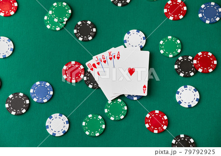Casino pocker chips and playing cards on green fabric table Casino pocker chips and playing cards on green fabric table 79792925
