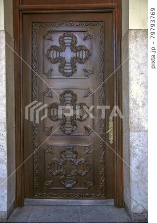 A polished wooden door, covered with carvings, at the entrance to the bell tower of St. Sarkis Cathedral in Tehran. 79793769