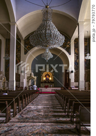 Hall for parishioners, altar with the icon of the Virgin, crystal chandeliers from under the vaulted ceilings in the Cathedral of St. Sarkis in Tehran Hall for parishioners, altar with the icon of the Virgin, crystal chandeliers from under the vaulted ceilings in the Cathedral of St. Sarkis in Tehran 79793770