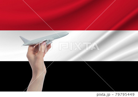 Airplane in hand with national flag of Yemen Travel to Yemen 79795449