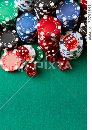 Pile of Casino pocker gambling chips and dices on green table Pile of Casino pocker gambling chips and dices on green table 79796341