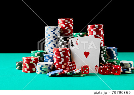 Casino chips, playing cards and dices on green fabric table Casino chips, playing cards and dices on green fabric table 79796369