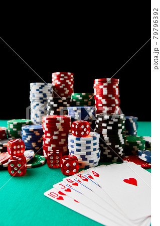 Casino chips, playing cards and dices on green fabric table Casino chips, playing cards and dices on green fabric table 79796392