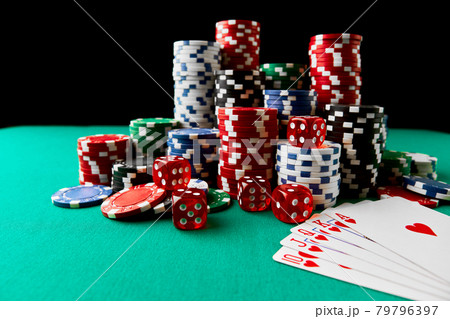 Casino chips, playing cards and dices on green fabric table 79796397